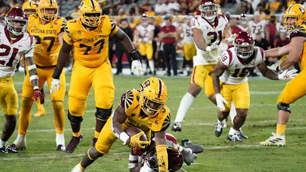 Nov 6, 2021; Tempe, Arizona, USA; Arizona State Sun Devils running back Rachaad White (3) dives for a touchdown over USC Trojans safety Xavion Alford (29) in the second half at Sun Devil Stadium. Mandatory Credit: Rob Schumacher-USA TODAY Sports